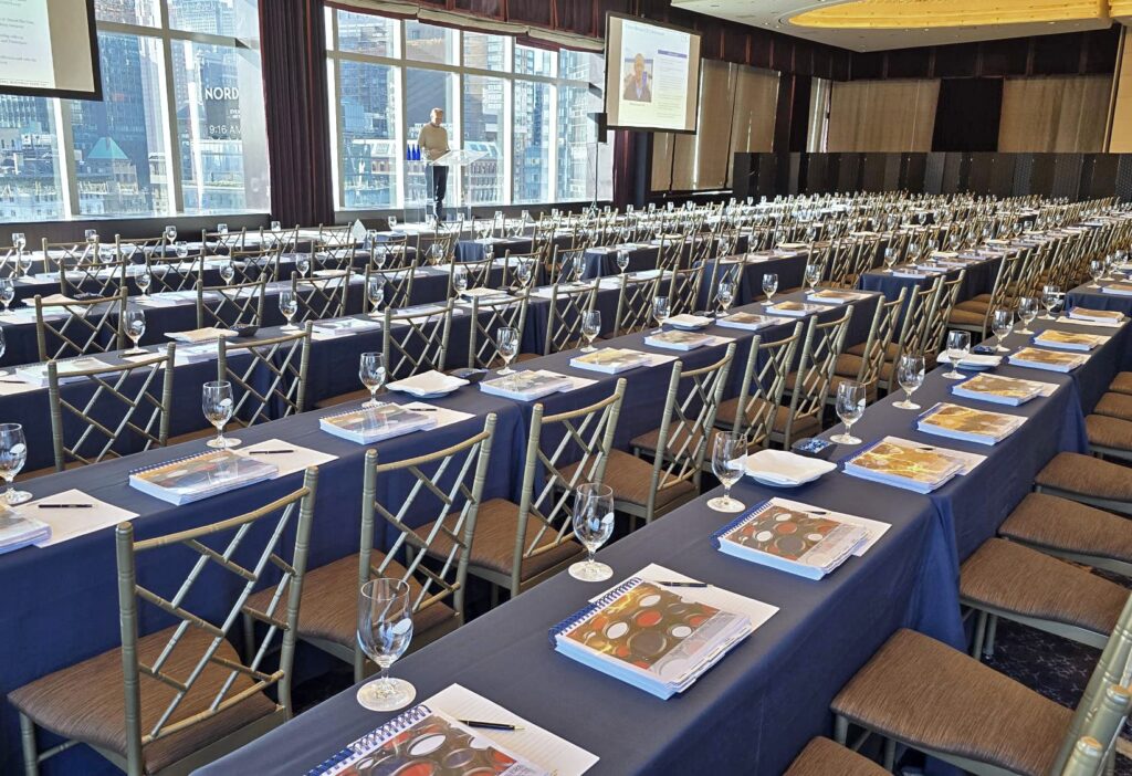 Conference room set for an investor meeting with printed pitch books and materials at each seat, showcasing ABG Print’s high-volume financial printing and event support capabilities for capital markets, investment banking, and private equity firms